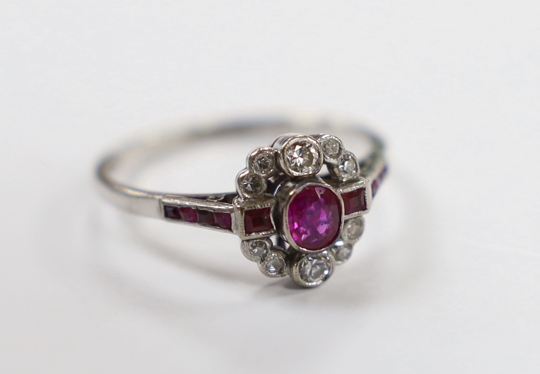 An Art Deco style 18ct white gold, ruby and diamond set cluster ring, size Q, gross weight 3.1 grams.